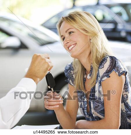 Stock Photography - A young woman buying a new car. Fotosearch