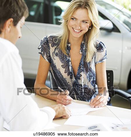 A young woman buying a new car View Large Photo Image Stock Photography - A young woman buying a new car. Fotosearch