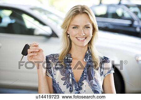 A young women with keys to a new car View Large Photo Image Stock Image - A young women with keys to a new car. Fotosearch