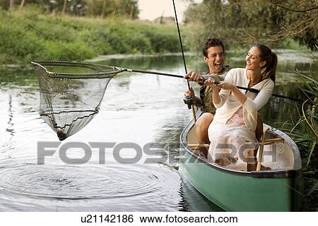 Stock Photograph - Young couple fishing . Fotosearch