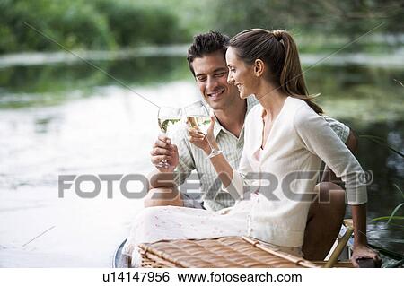 Young couple having a picnic View Large Photo Image Stock Photograph - Young couple having a picnic. Fotosearch
