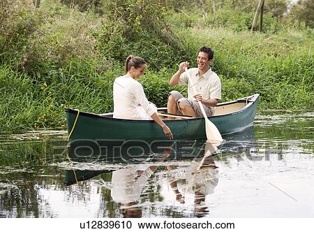 Young couple in a rowing boat View Large Photo Image Stock Image - Young couple in a rowing boat. Fotosearch