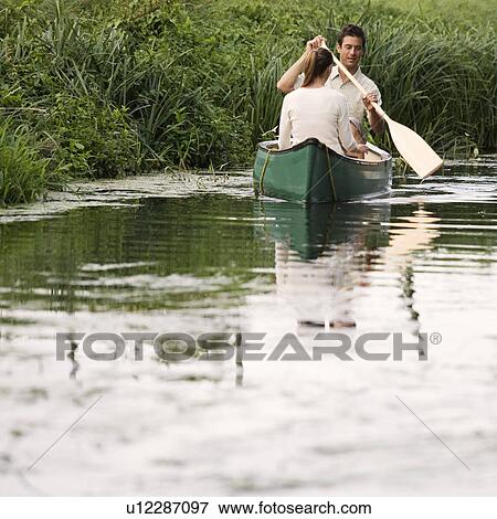 Young couple in a rowing boat View Large Photo Image Stock Photo - Young couple in a rowing boat. Fotosearch