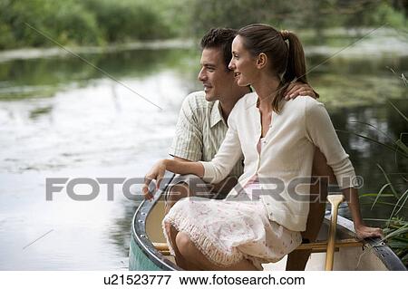Young couple in a rowing boat View Large Photo Image Stock Photo - Young couple in a rowing boat. Fotosearch