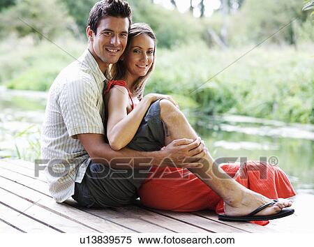 Young couple sitting in the sun View Large Photo Image Stock Photography - Young couple sitting in the sun. Fotosearch