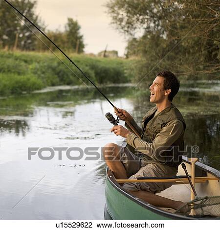Stock Image - Young man fishing. Fotosearch
