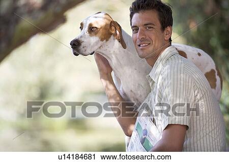 Young man with a pet dog View Large Photo Image Stock Image - Young man with a pet dog. Fotosearch