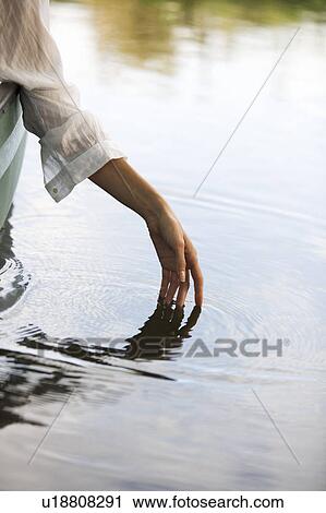 Stock Image - Young woman sitting in a boat. Fotosearch