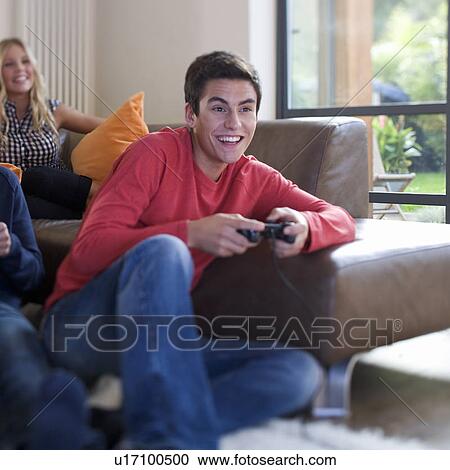 A teenage boy playing a computer game View Large Photo Image Stock Image - A teenage boy playing a computer game. Fotosearch