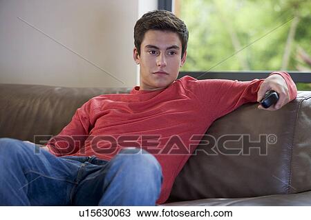 A teenage boy watching television View Large Photo Image Stock Image - A teenage boy watching television. Fotosearch
