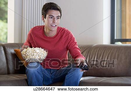 A teenage boy watching television View Large Photo Image Stock Photo - A teenage boy watching television. Fotosearch