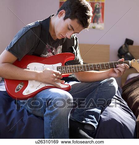 A teenage boy with a guitar View Large Photo Image Stock Photo - A teenage boy with a guitar. Fotosearch