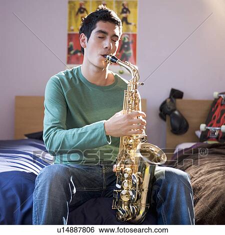 Stock Photograph - A teenage boy with a saxophone. Fotosearch