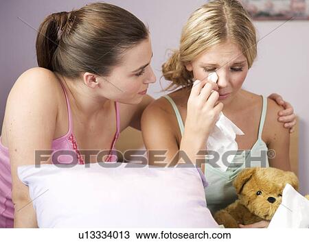 A teenage girl comforting her friend View Large Photo Image Stock Image - A teenage girl comforting her friend. Fotosearch