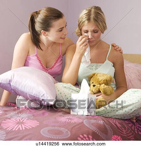 A teenage girl comforting her friend View Large Photo Image Stock Photograph - A teenage girl comforting her friend. Fotosearch