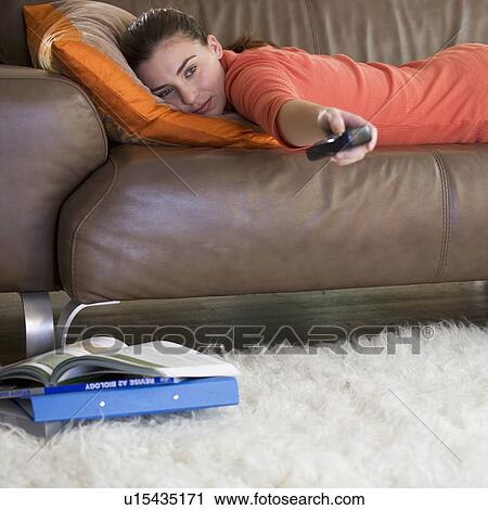 Stock Image - A teenage girl watching television. Fotosearch