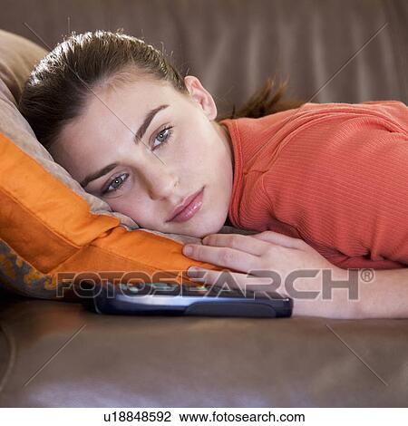 A teenage girl watching television View Large Photo Image Stock Image - A teenage girl watching television. Fotosearch