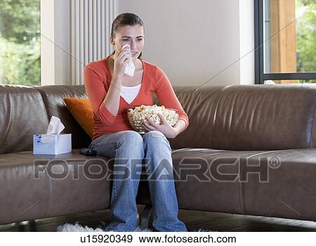 Stock Photo - A teenage girl watching television. Fotosearch