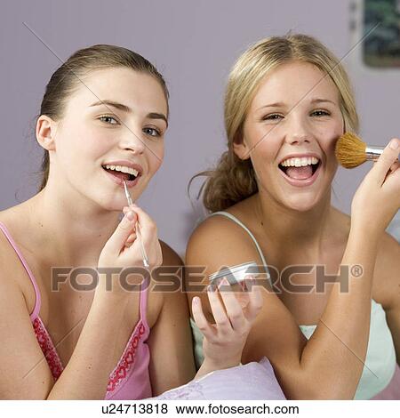 Stock Photo - Two teenage girls applying make up. Fotosearch