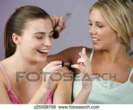 Two teenage girls applying make up View Large Photo Image Stock Photograph - Two teenage girls applying make up. Fotosearch