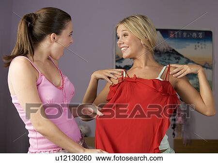 Two teenage girls choosing outfits View Large Photo Image Stock Image - Two teenage girls choosing outfits. Fotosearch