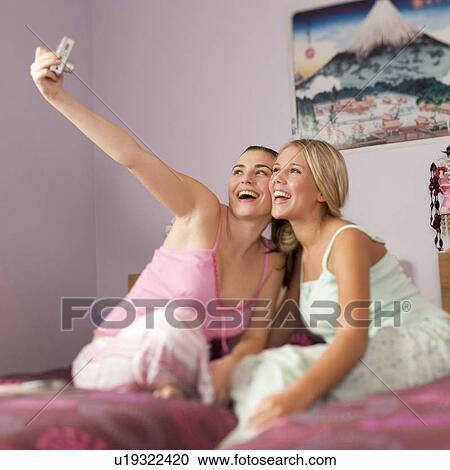 Two teenage girls in a bedroom View Large Photo Image Stock Image - Two teenage girls in a bedroom. Fotosearch