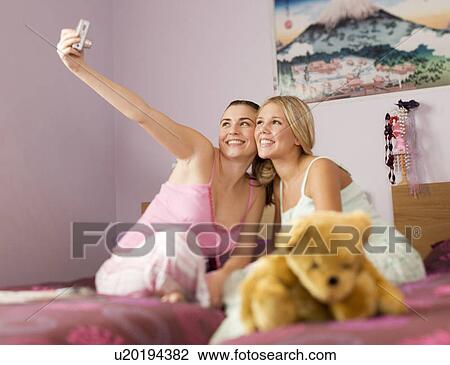 Two teenage girls in a bedroom View Large Photo Image Stock Image - Two teenage girls in a bedroom. Fotosearch