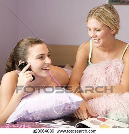 Two teenage girls in a bedroom View Large Photo Image Stock Photo - Two teenage girls in a bedroom. Fotosearch