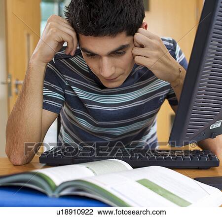 A teenage boy studying View Large Photo Image Stock Image - A teenage boy studying. Fotosearch