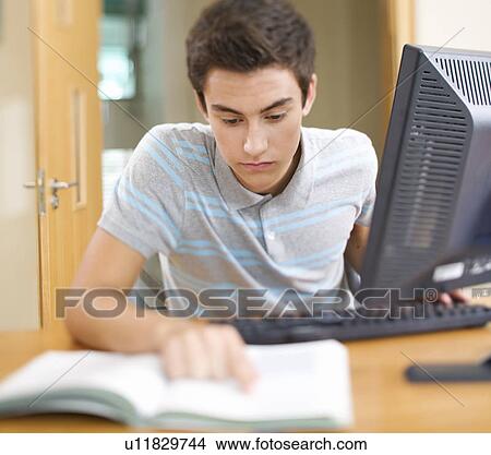 A teenage boy using a computer View Large Photo Image Picture - A teenage boy using a computer. Fotosearch