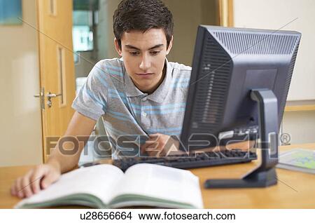 A teenage boy using a computer View Large Photo Image Picture - A teenage boy using a computer. Fotosearch