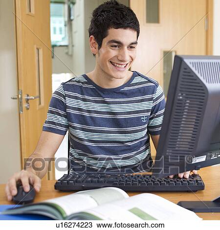 A teenage boy using a computer View Large Photo Image Stock Image - A teenage boy using a computer. Fotosearch