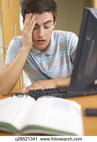 A teenage boy using a computer View Large Photo Image Stock Image - A teenage boy using a computer. Fotosearch