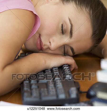 A teenage girl asleep at a computer View Large Photo Image Stock Photo - A teenage girl asleep at a computer. Fotosearch