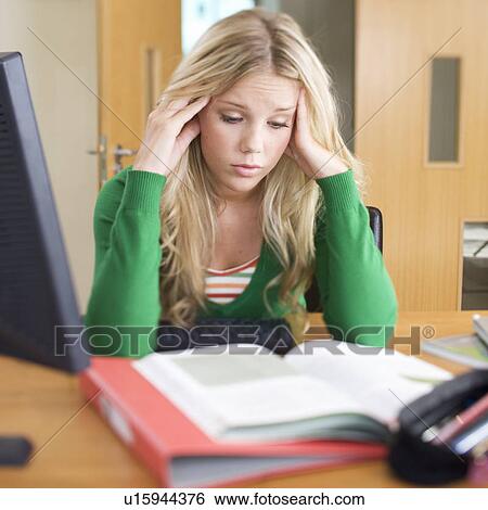 Stock Photograph - A teenage girl studying. Fotosearch
