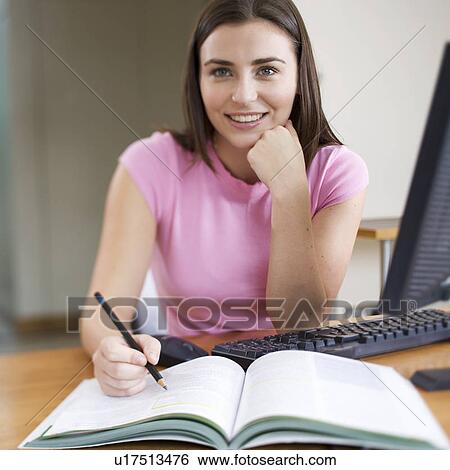 Stock Photograph - A teenage girl studying. Fotosearch