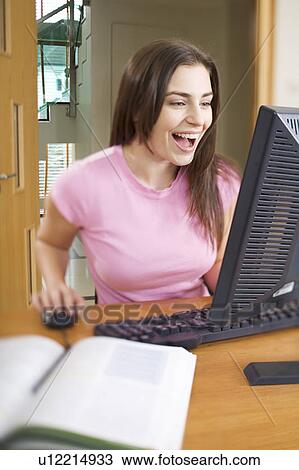 A teenage girl using a computer View Large Photo Image Stock Image - A teenage girl using a computer. Fotosearch