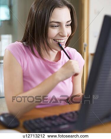 A teenage girl using a computer View Large Photo Image Stock Image - A teenage girl using a computer. Fotosearch
