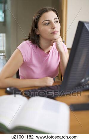 A teenage girl using a computer View Large Photo Image Stock Image - A teenage girl using a computer. Fotosearch