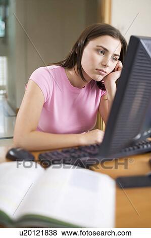 A teenage girl using a computer View Large Photo Image Stock Photo - A teenage girl using a computer. Fotosearch