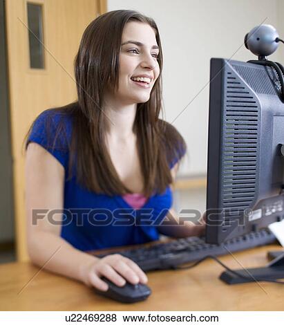 Stock Photo - A teenage girl using a computer. Fotosearch