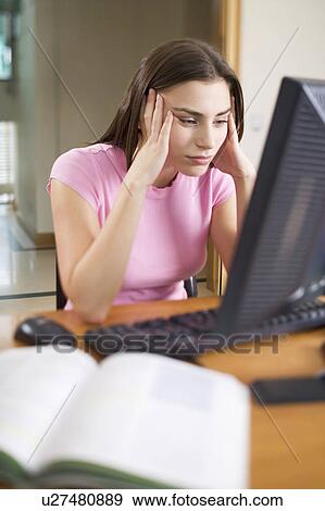 A teenage girl using a computer View Large Photo Image Stock Photo - A teenage girl using a computer. Fotosearch
