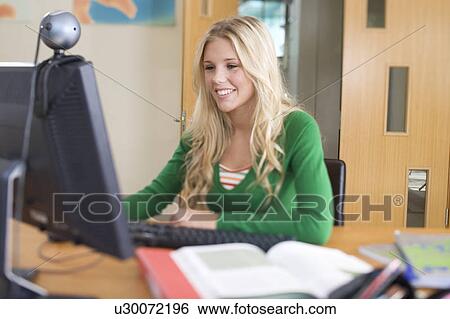 Stock Photograph - A teenage girl using a computer. Fotosearch