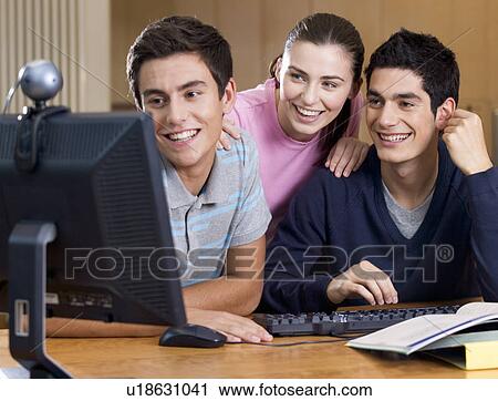 Three teenage friends using a computer View Large Photo Image Stock Image - Three teenage friends using a computer. Fotosearch