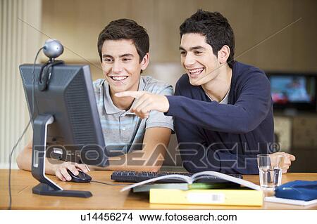 Two teenage boys studying using a computer View Large Photo Image Picture - Two teenage boys studying using a computer. Fotosearch