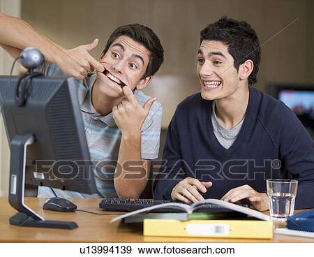 Two teenage boys studying using a computer View Large Photo Image Stock Photo - Two teenage boys studying using a computer. Fotosearch