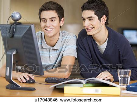 Two teenage boys studying using a computer View Large Photo Image Stock Photograph - Two teenage boys studying using a computer. Fotosearch