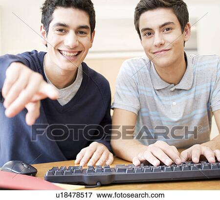 Two teenage boys using a computer View Large Photo Image Stock Photo - Two teenage boys using a computer. Fotosearch