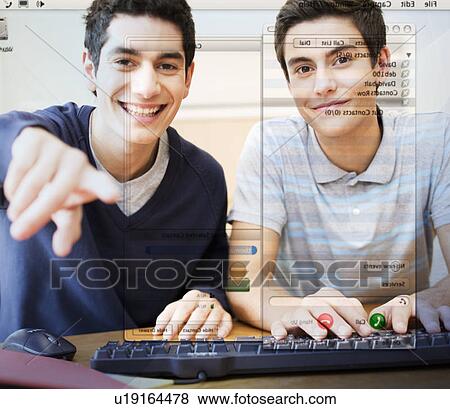 Stock Photo - Two teenage boys using a computer. Fotosearch