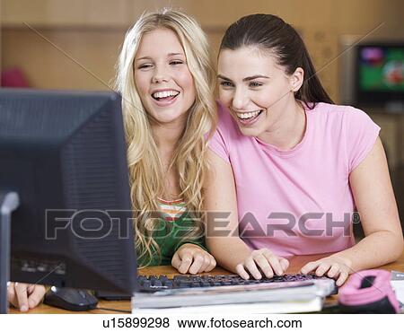 Stock Photo - Two teenage girls using a computer. Fotosearch